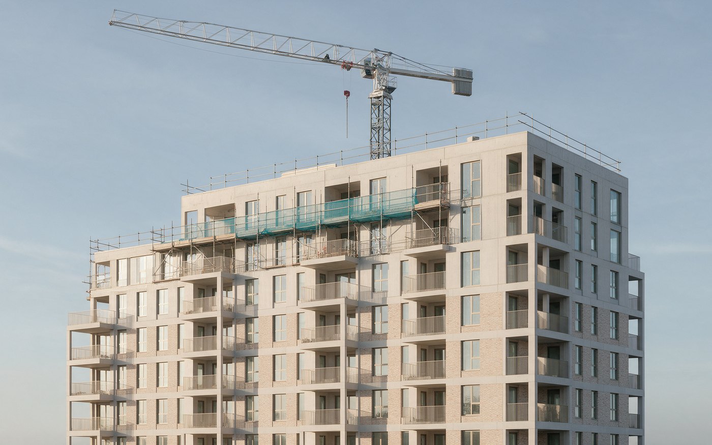 A new block of flats near completion, a tower crane behind it.
